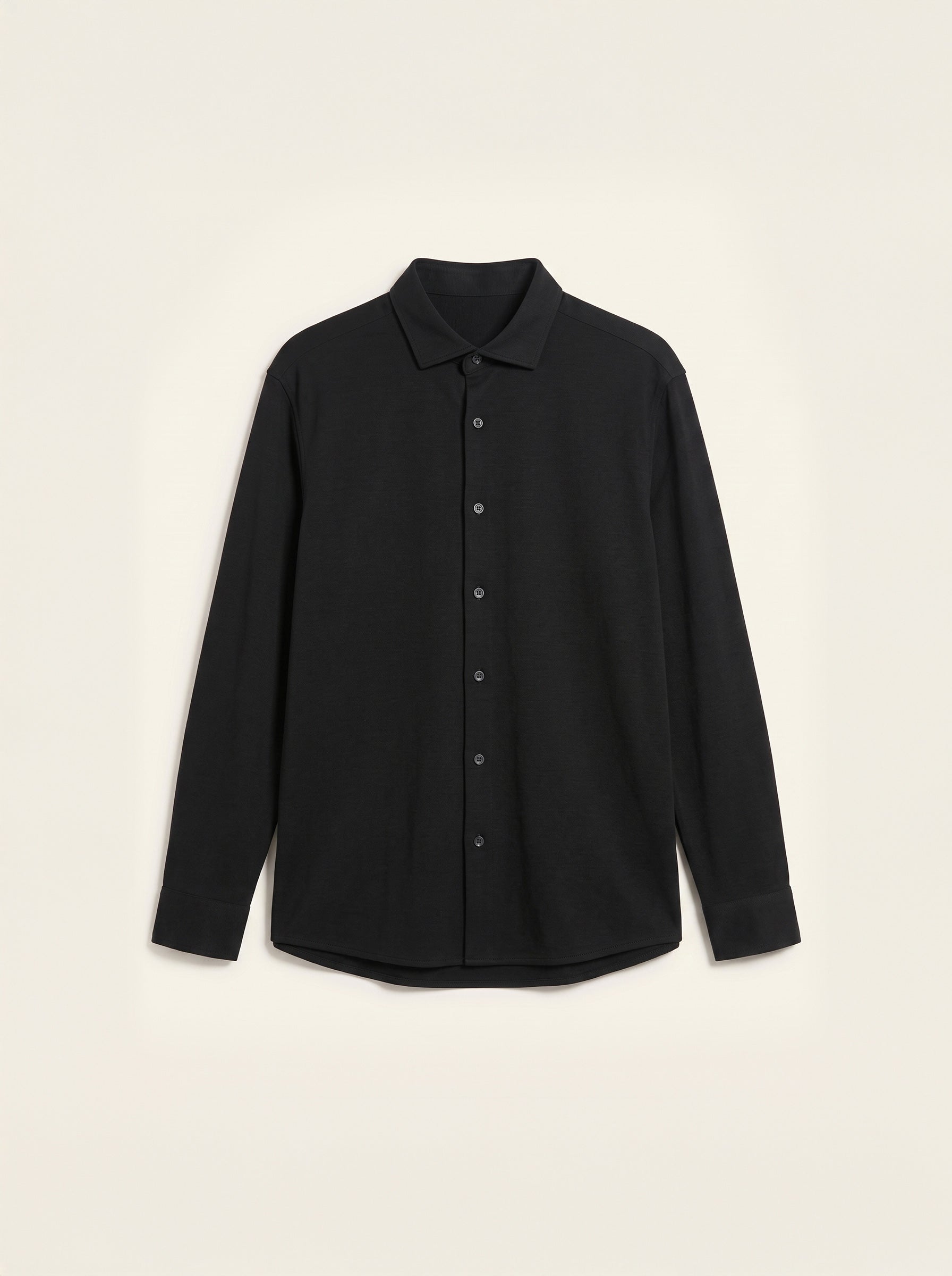 #Jet-Black_group A black long-sleeve button-up shirt shown from the back, laid flat against a light cream background.