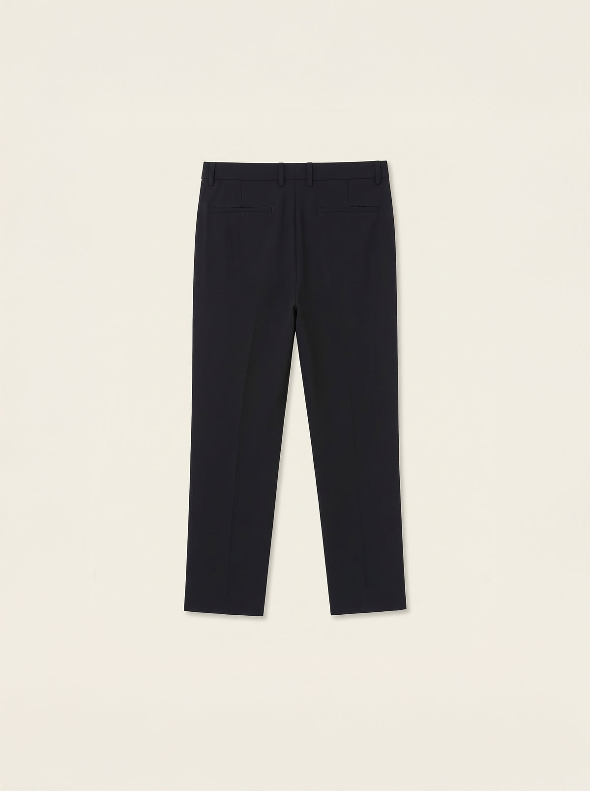 #Jet-Black_group A pair of dark navy blue trousers laid flat against a light cream background.