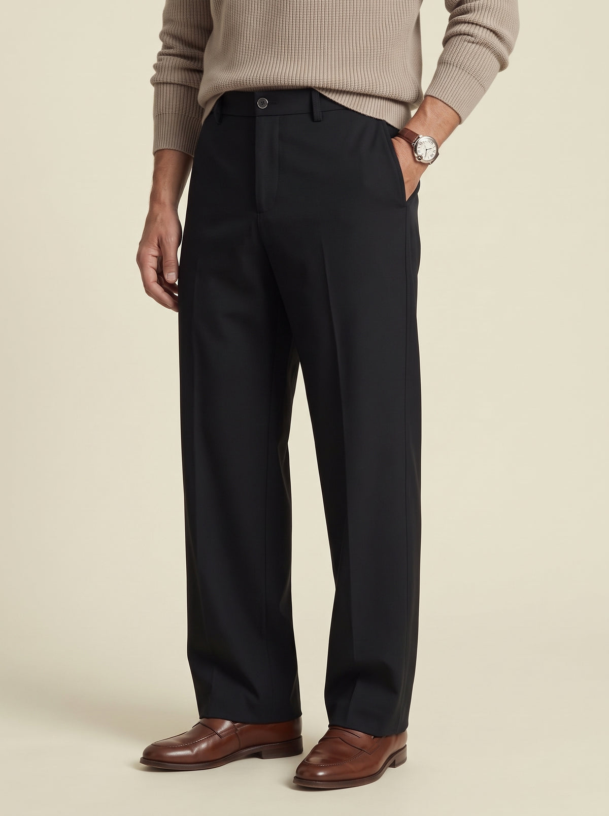 #Jet-Black_group A man wearing black straight-leg dress pants, a beige ribbed sweater, brown leather shoes, and a silver watch, standing against a solid beige background.