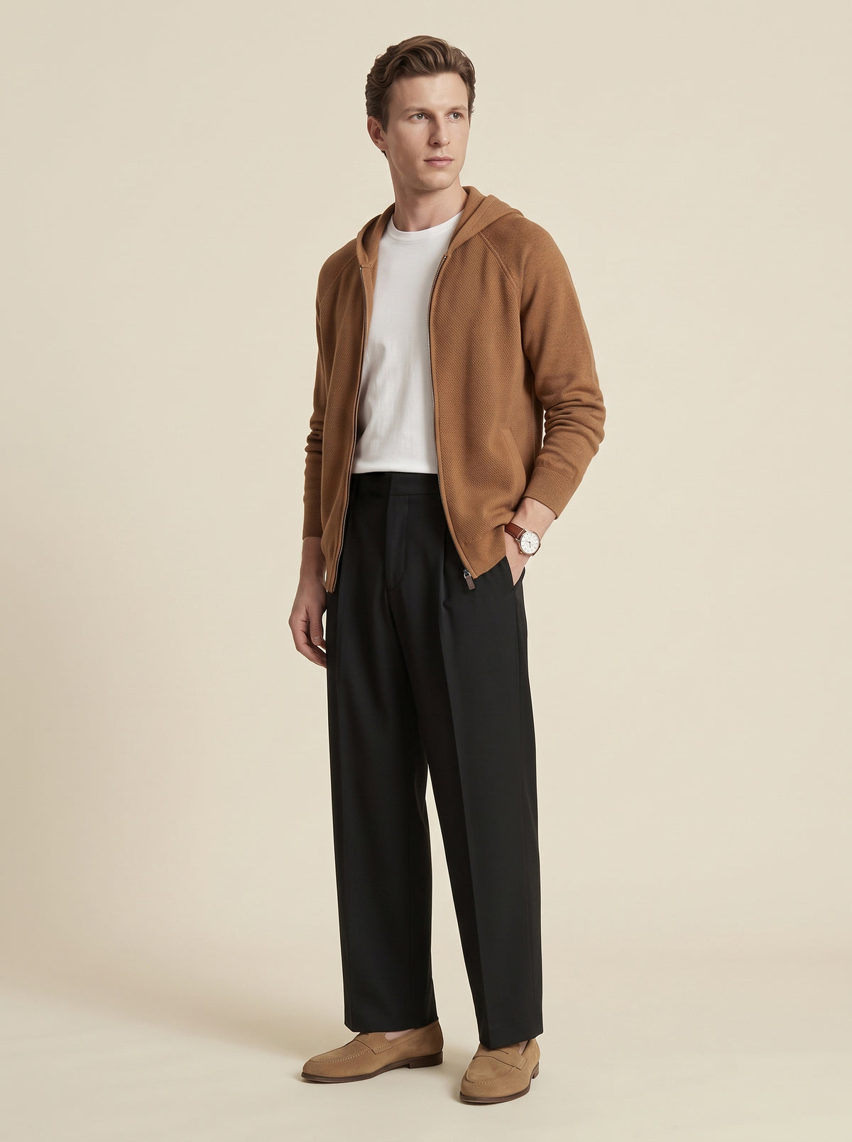 #Cedar-Brown_group A man modeling a brown hooded zip-up cardigan over a white t-shirt and black trousers, standing against a solid beige studio background.