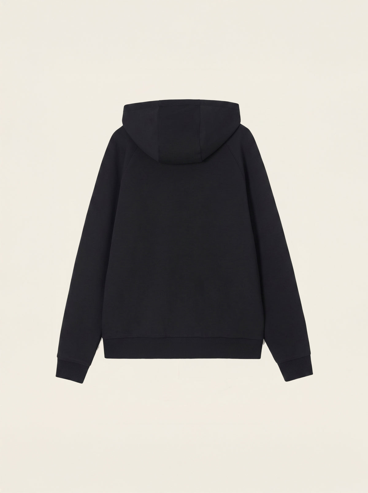 #Jet-Black_group A black pullover hoodie shown from the back, photographed flat against a light cream background.